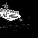 Black and white photo of the famous Las Vegas sign illuminated at night.