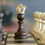A brown pawn with a crown stands prominently on a chessboard, symbolizing strategic play.