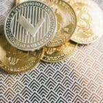 tokenized real world assets visual showing real estate bonds and gold turning into digital tokens