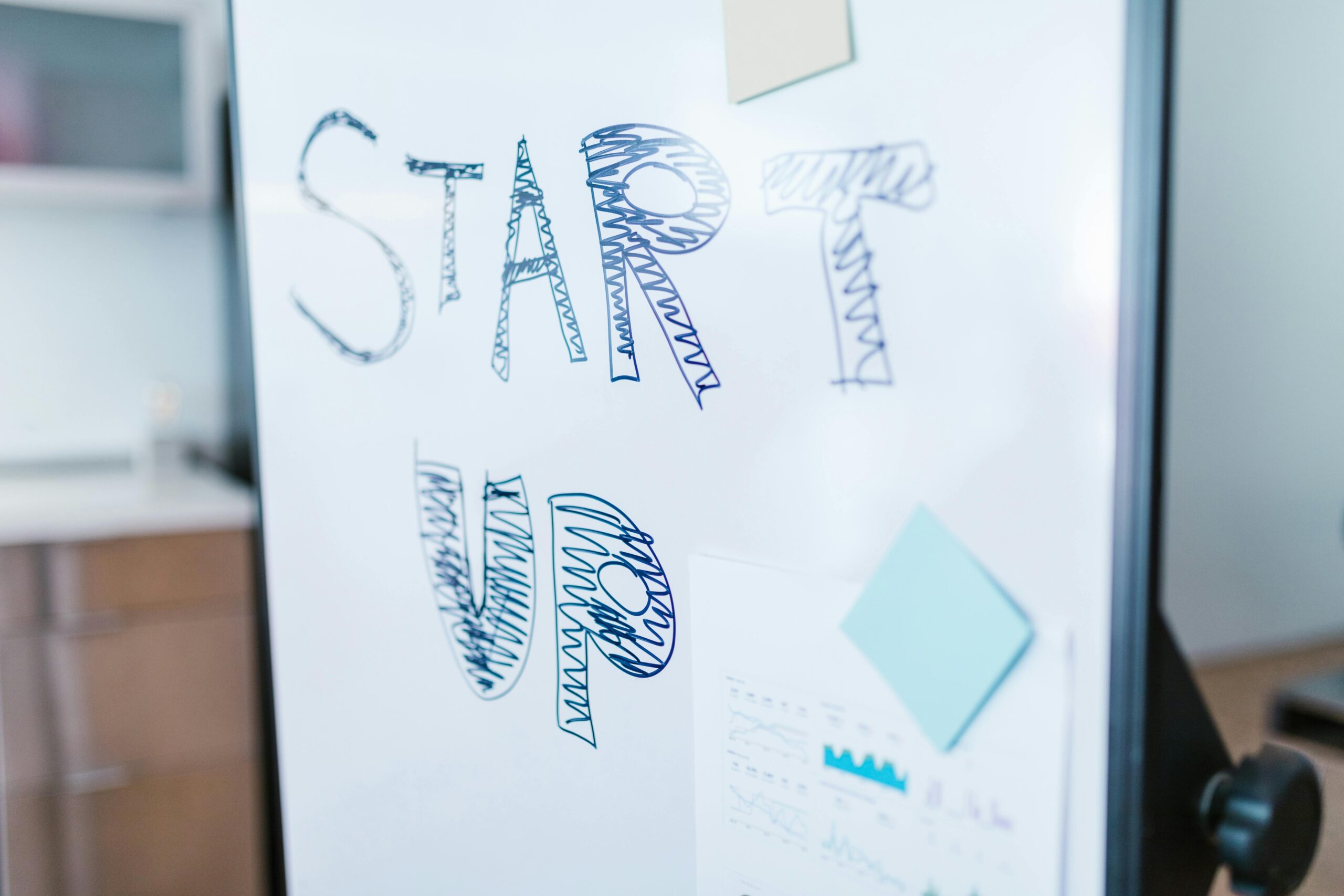 Creative startup concept handwritten on a whiteboard, symbolizing innovation in business.
