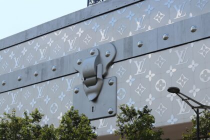 Close-up of Louis Vuitton facade with iconic logo design in Paris, France.
